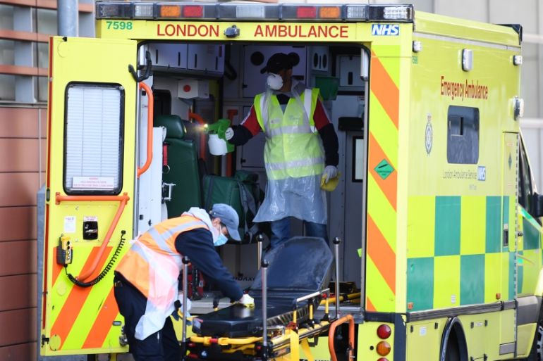 Staff wearing personal protective equipment (PPE) disinfect a London Ambulance outside The Royal London Hospital in east London on April 19, 2020. The number of people in Britain who have died in hosp