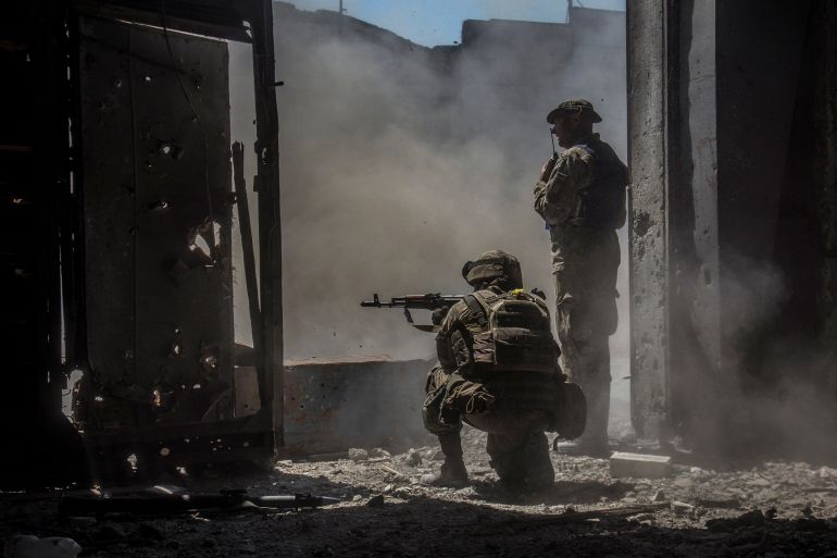 Ukrainian service members inside a damaged building in the industrial area of the city of Severodonetsk, Ukraine June 20, 2022