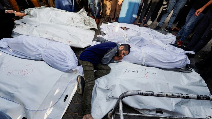 A mourner reacts amidst the bodies as people attend a funeral of Palestinians killed in Israeli strikes
