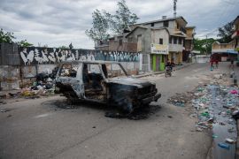 A burnt-out car is seen during a protest against insecurity in Port-au-Prince, Haiti on April 16, 2025.