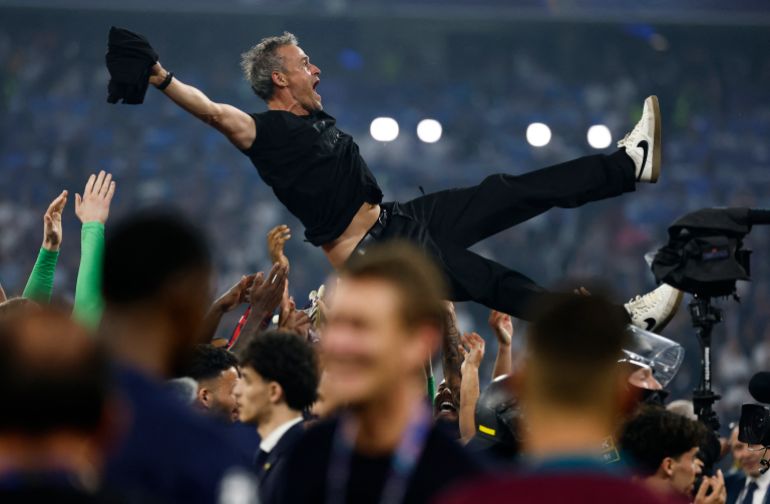 Champions League - Final - Paris St Germain v Inter Milan - Allianz Arena, Munich, Germany - May 31, 2025 Paris St Germain players celebrate winning the Champions League by throwing Luis Enrique in the air