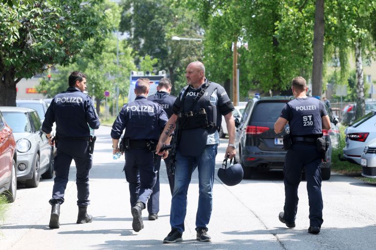 Police officers attend the scene of a shooting at a school in Graz, Austria, Tuesday, June 10, 2025.