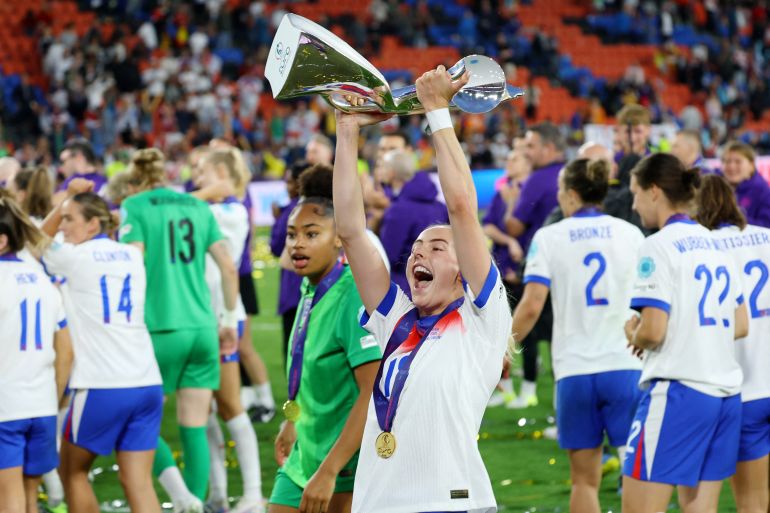 Chloe Kelly holds up the trophy