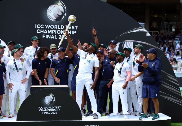 South Africa's Kagiso Rabada lifts the ICC Test Championship Mace on the podium with teammates after winning the final